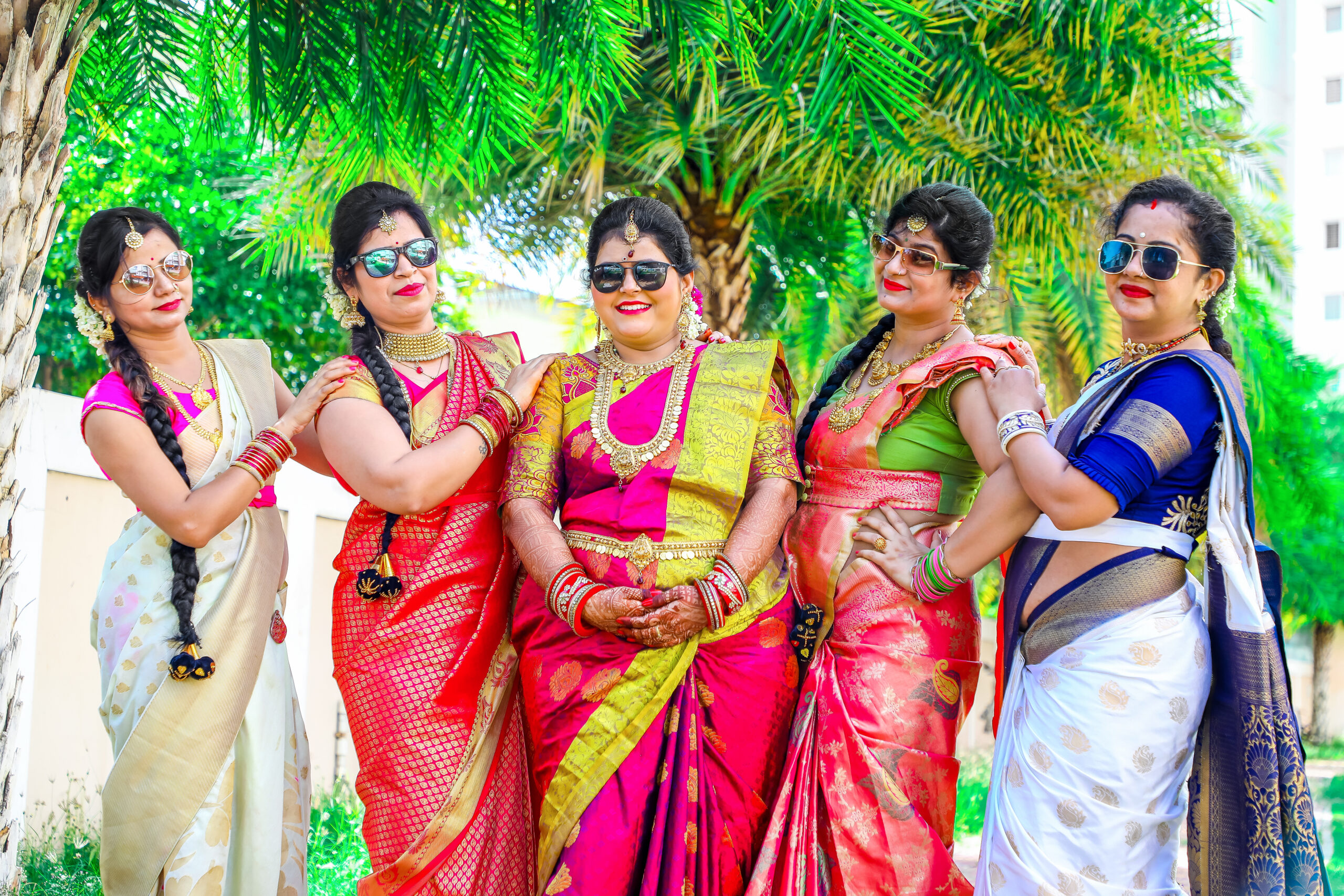 Four women in colorful saris posing for the camera during Gayathri's Maternity Photoshoot by ak photography coimbatore