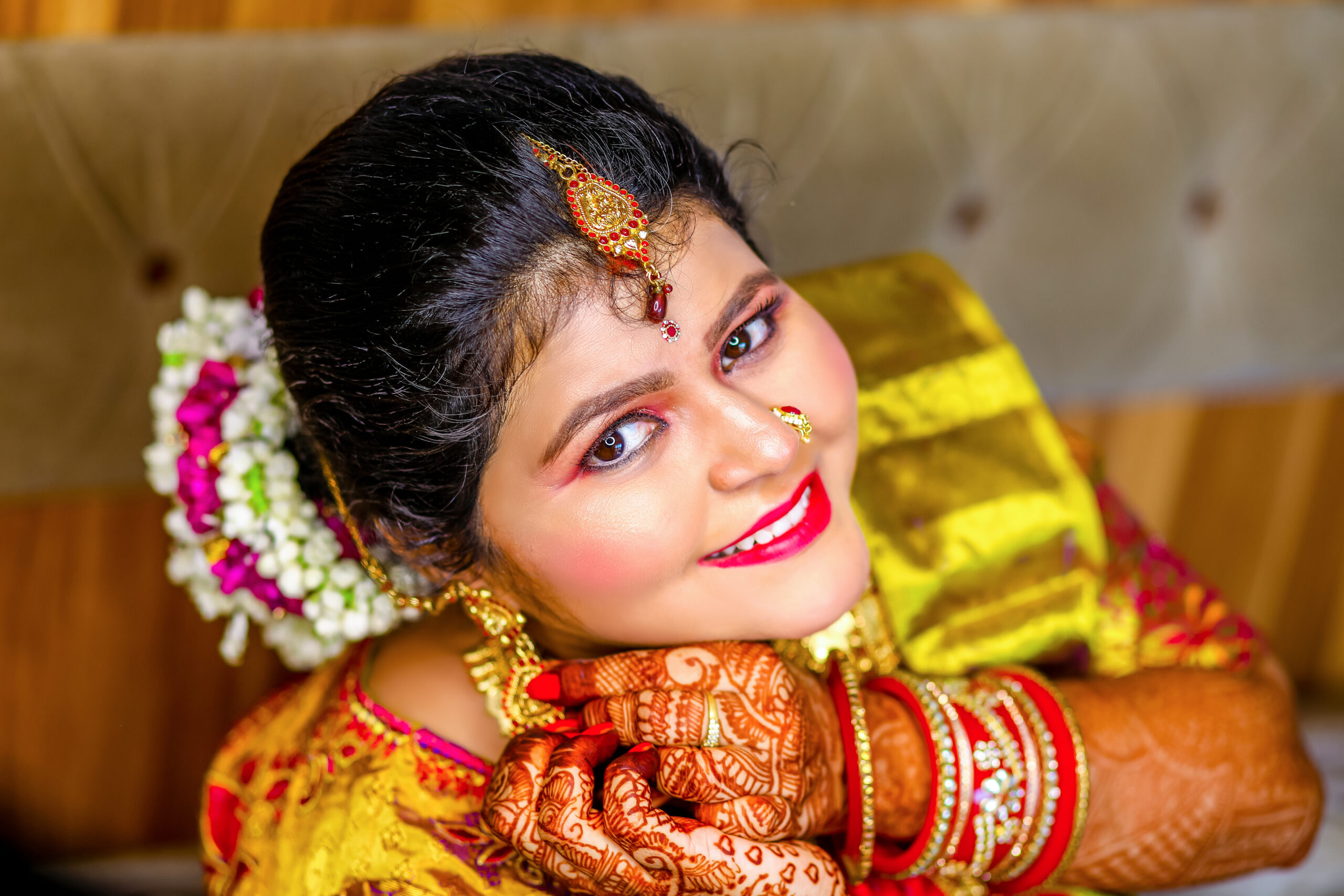 Bridal photoshoot by AK Photography Coimbatore: A stunning bride in a white gown, surrounded by flowers, posing for the camera