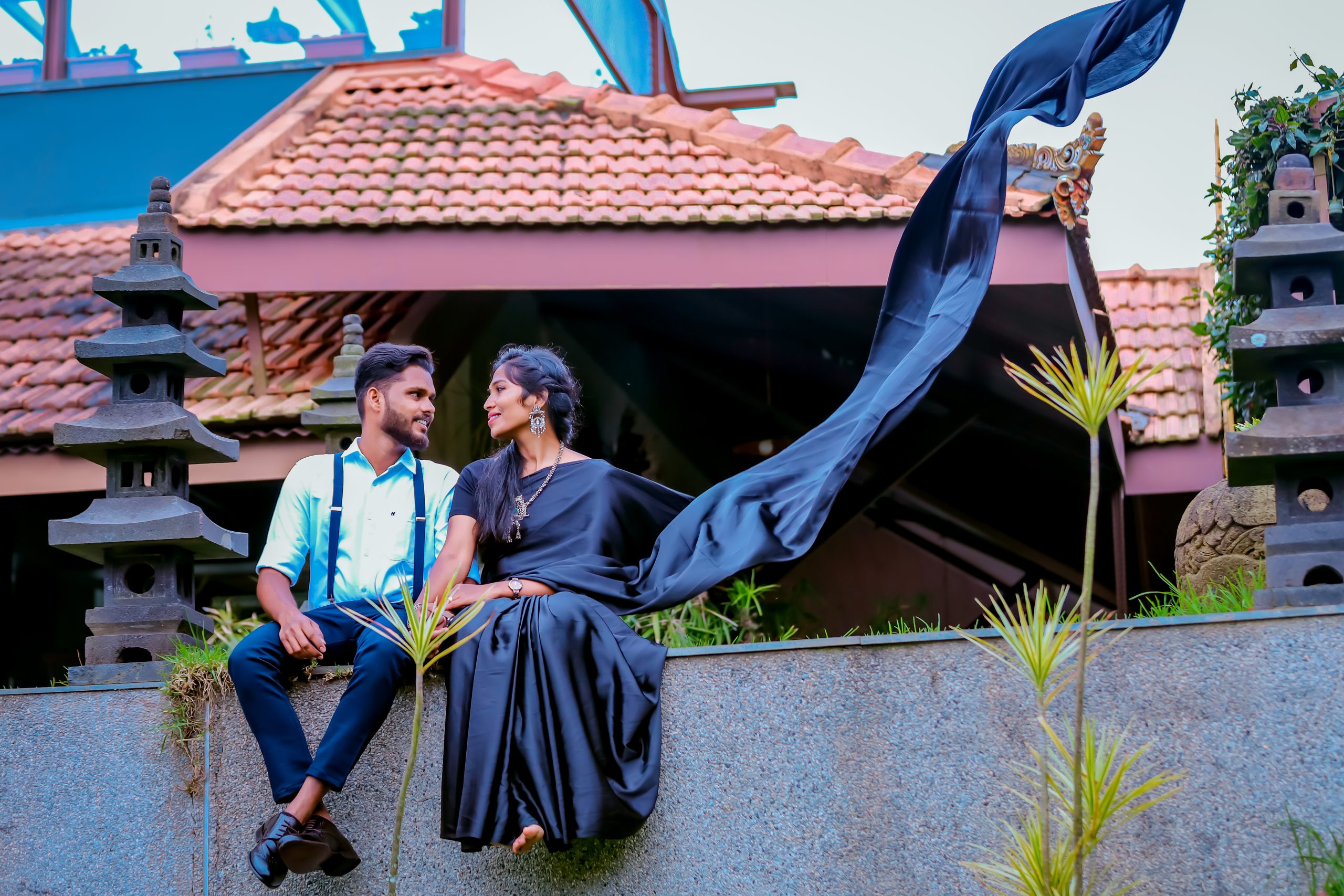 A man and woman sitting on a ledge. Enchanting Pre-Wedding Couple Shoot of Krishna & Nivetha in Ooty,
