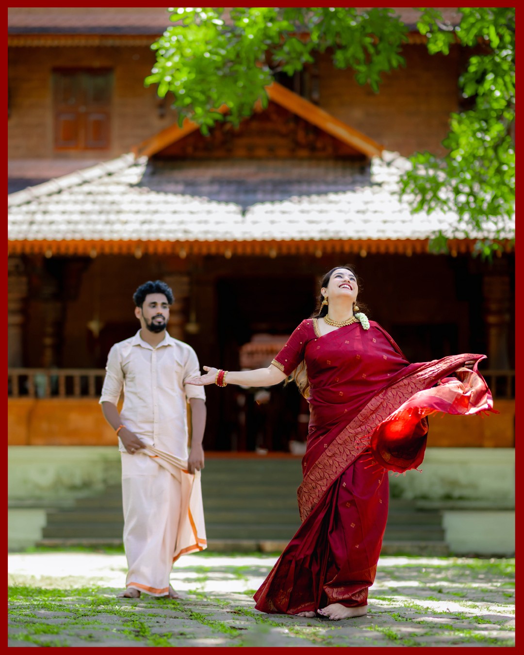 Graceful bride Sneha twirling in traditional silk saree at Kurumboor Mana Palace courtyard