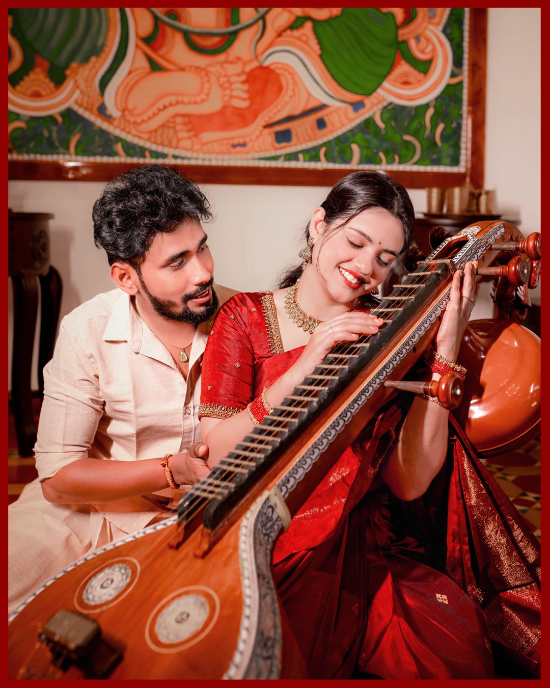 Intimate pre-wedding portrait of Sneha and Deepak playing the strings of Saraswati Veena together at Kurumboor Mana