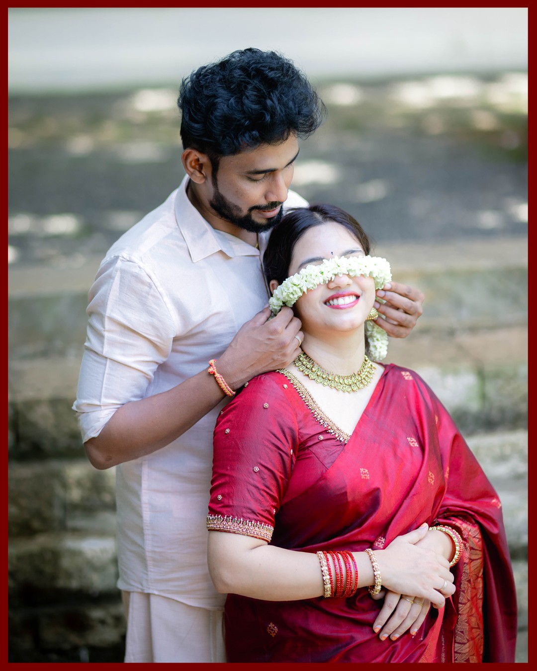 Playful candid pre-wedding moment of Sneha covering Deepak eyes with fresh jasmine strands