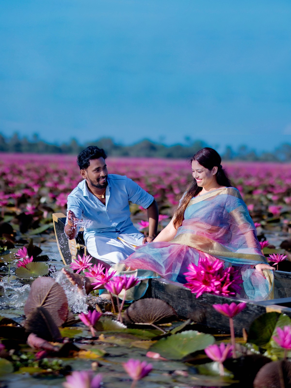 Joyful water splashing candid pre-wedding moments of Shneka and Deepak on boat at Malarikal by AK Photography