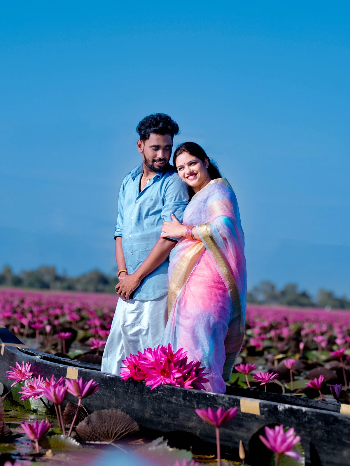 Tender head on shoulder standing couple portrait of Shneka and Deepak on boat in Malarikal by AK Photography